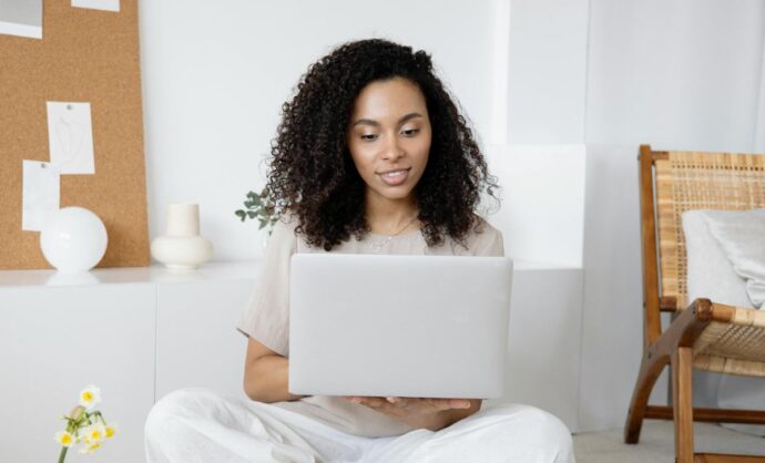 Ragazza che lavora su un laptop bianco